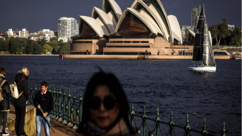 Tourists Capture Moments Against Iconic Sydney Opera House on a Winter’s Day